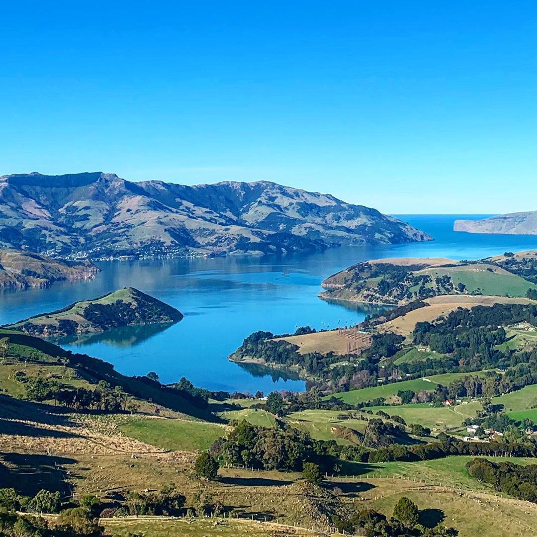 BaliUltra's tweet photo. The beautiful harbourside town of Akaroa, where the Unity Ultra will begin. Our mission to use the endurance to make a positive impact is taking us to New Zealand. Our event is about standing up to hate and bringing people together. Visit https://t.co/TXB5znjqHv https://t.co/HMrbOYpKP9