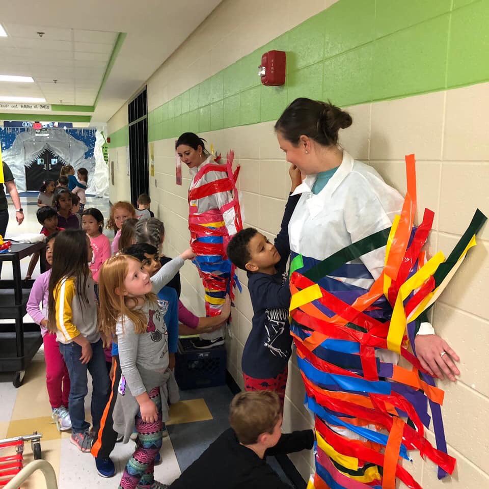 lisagarosi's tweet photo. Late posting... Friday was so fun! Top classes for raising money for the fun run.. taped to the wall with @mstoneCWES and @MsBowensClass ... @CogburnWoodsES and I said I would not stay on the wall...@CogburnWoodsPTO https://t.co/MLrTi4ukNi