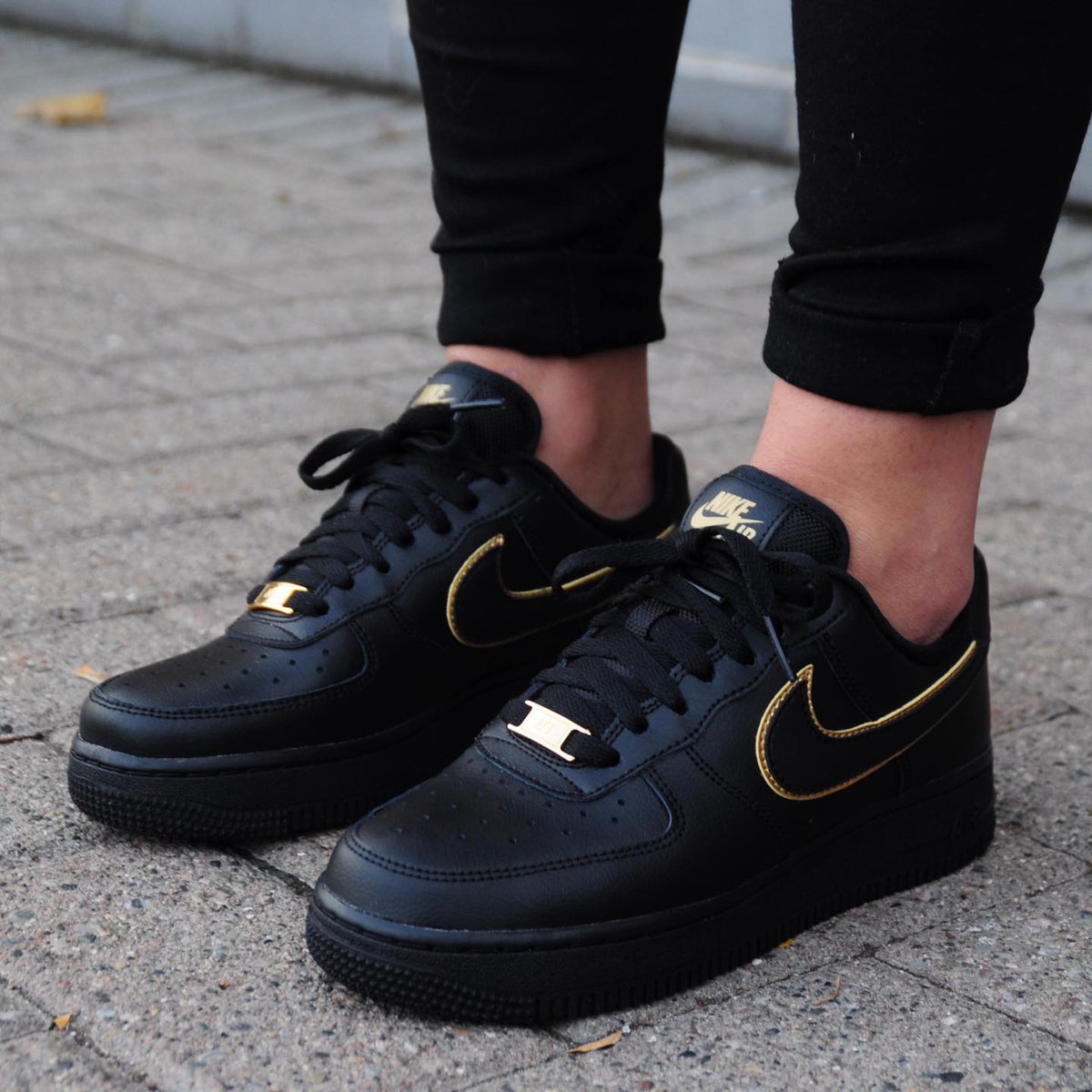 black nike with gold swoosh womens