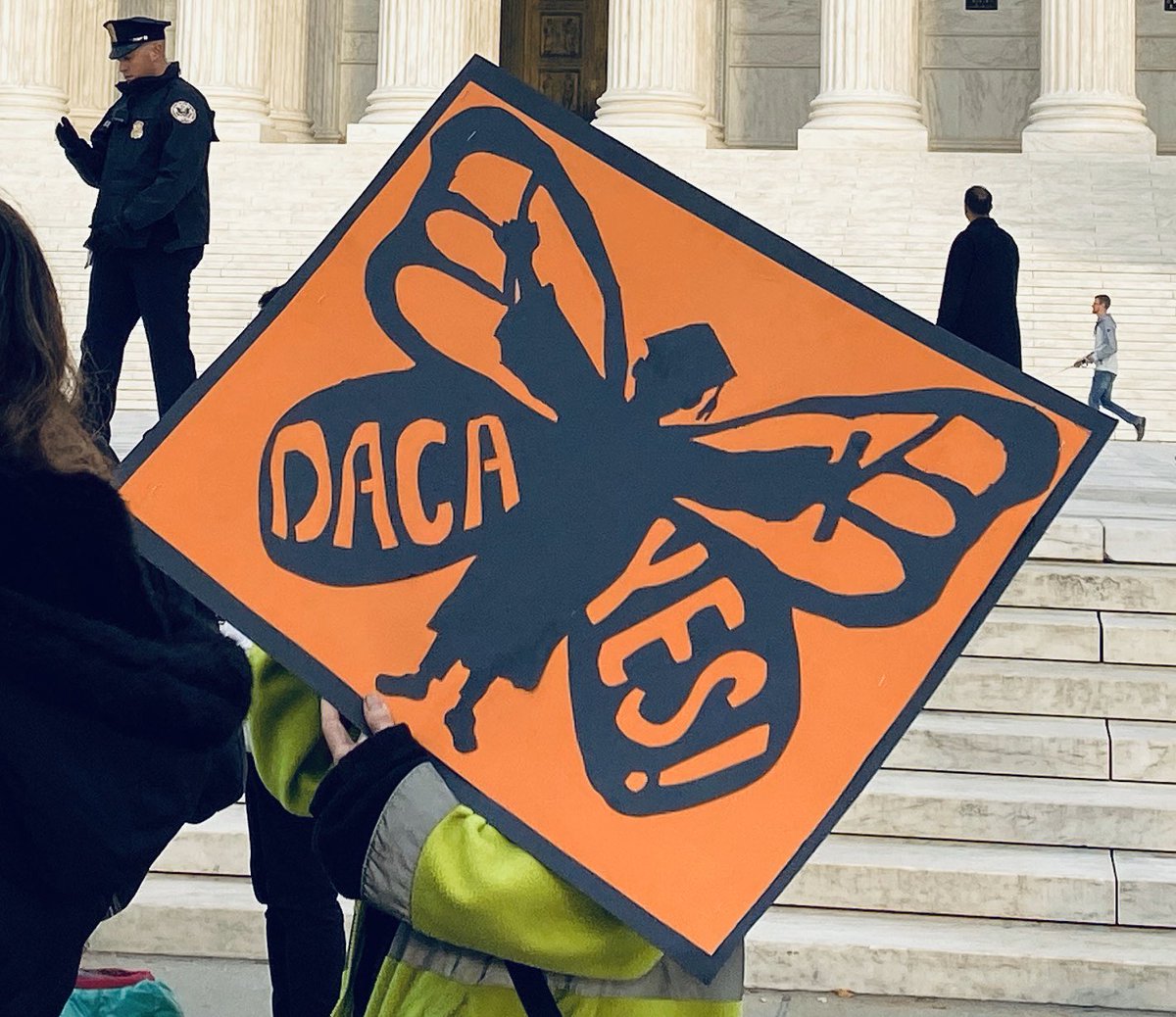 Sign in front of the Supreme Court says “DACA YES!”