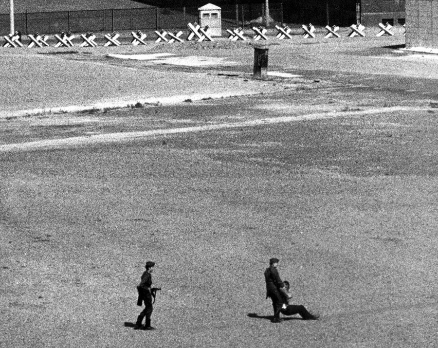 cmortolani's tweet photo. East German border guards carry away a refugee who was wounded by East German machine-gun fire as he dashed through Communist border installations toward the #BerlinWall, 1971-via @TheAtlantic #SocialismKills #VoteFreedomFirst #VeteransDay https://t.co/0fKL0BKvjV