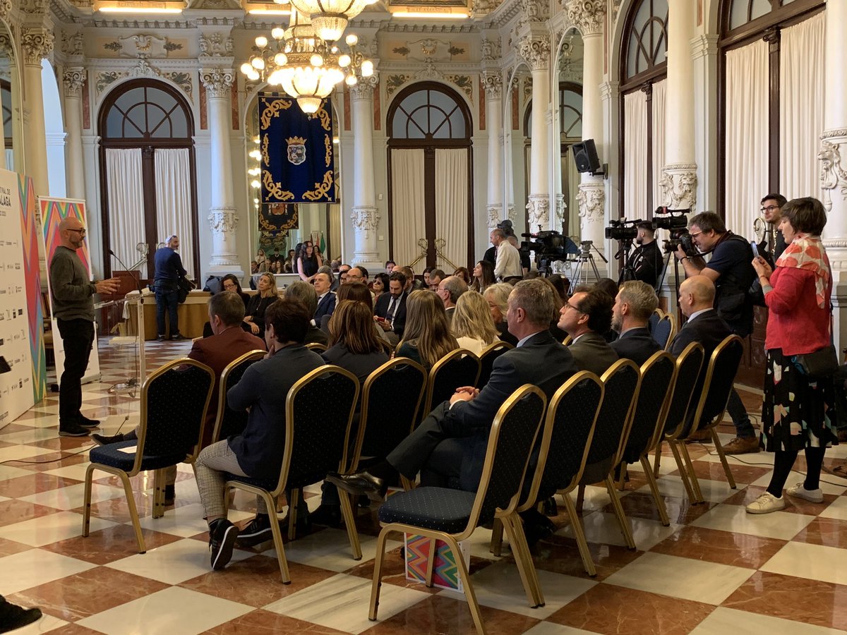 “Una angulosa alfombra roja que zigzaguea en el centro del cartel y nos conduce desde <a href="/TeatroCervantes/">Teatro Cervantes</a>, donde posan nuestras estrellas de cine, hasta c/ Larios, por la que cualquier espectador del Festival puede transitar. Es la sofisticación de sus noches y la sencillez del día”