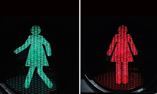 Woman crosswalk icons. Green light she's walking, red light she's standing still.