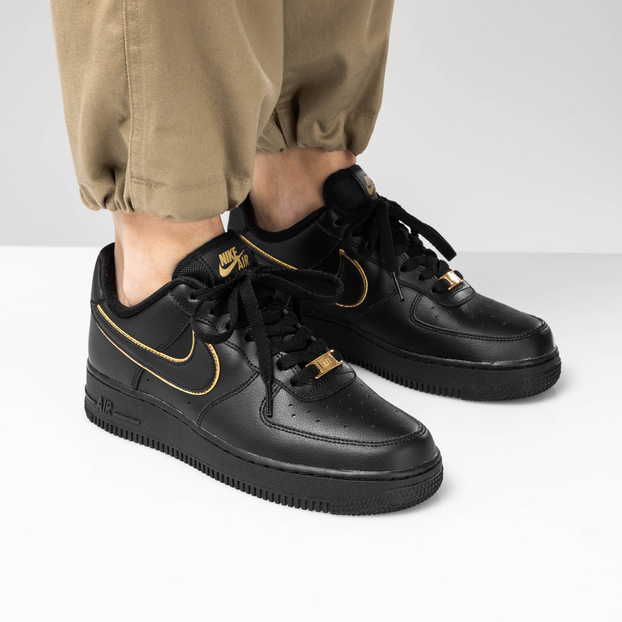 black nikes with gold swoosh