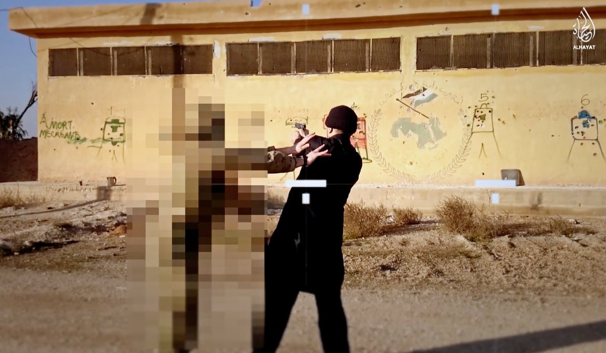 25. The mysterious instructor is apparently wearing combat gear and a balaclava, but he was also pixelated by ISIS media to make his identification even harder.