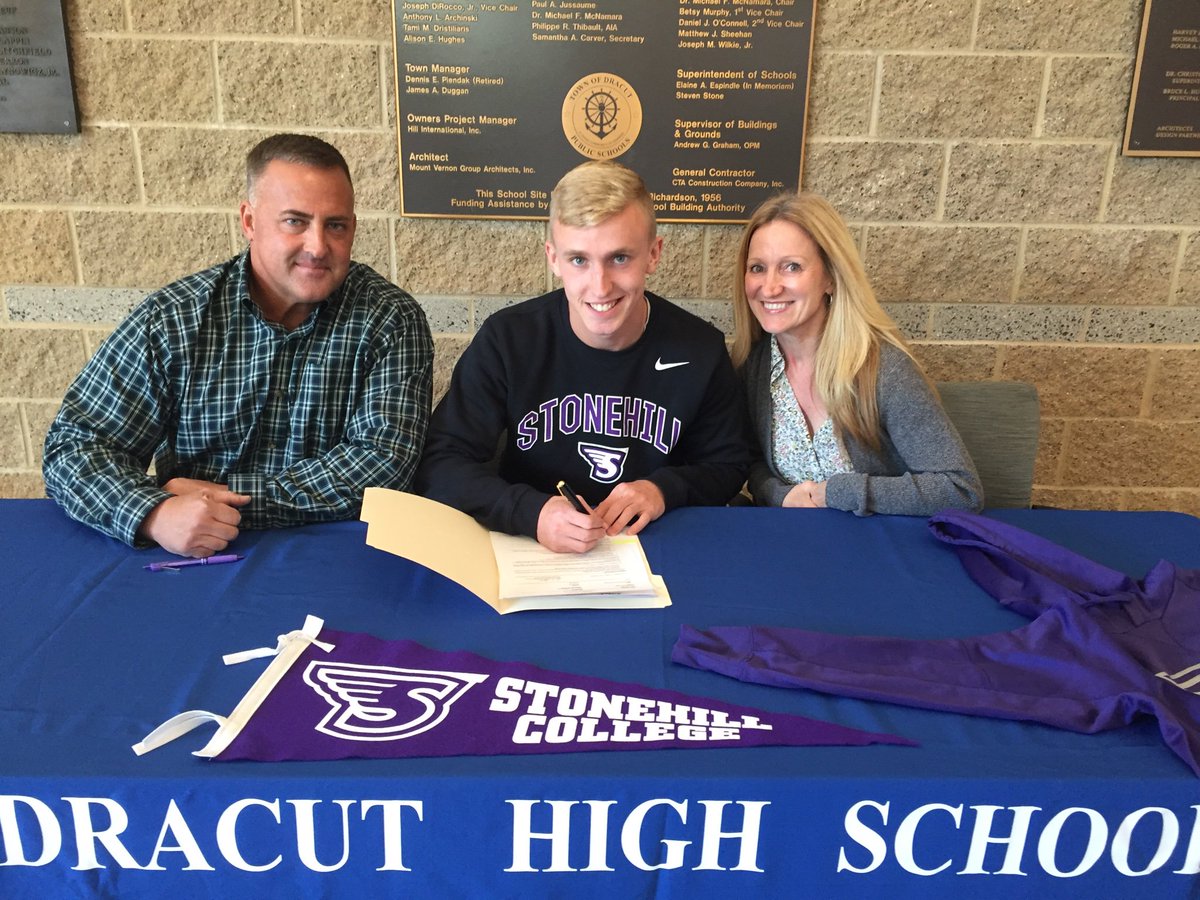 DHS soccer standout Brendan Davis is all smiles as he signs his Letter of Intent to study and play soccer at Stonehill College.  Parents Jennifer and John join their son at DHS.  Hard work (and talent) pay off!