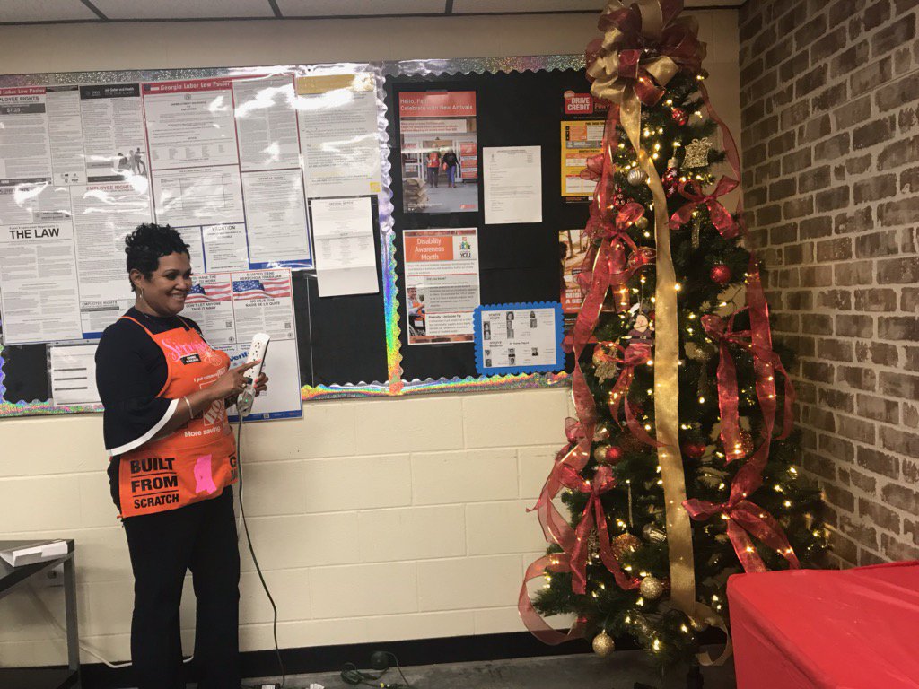HomeDepot110's tweet photo. Mrs. Sirrenthia lighting #store0110 Christmas tree!! https://t.co/FIxMPiWLUK