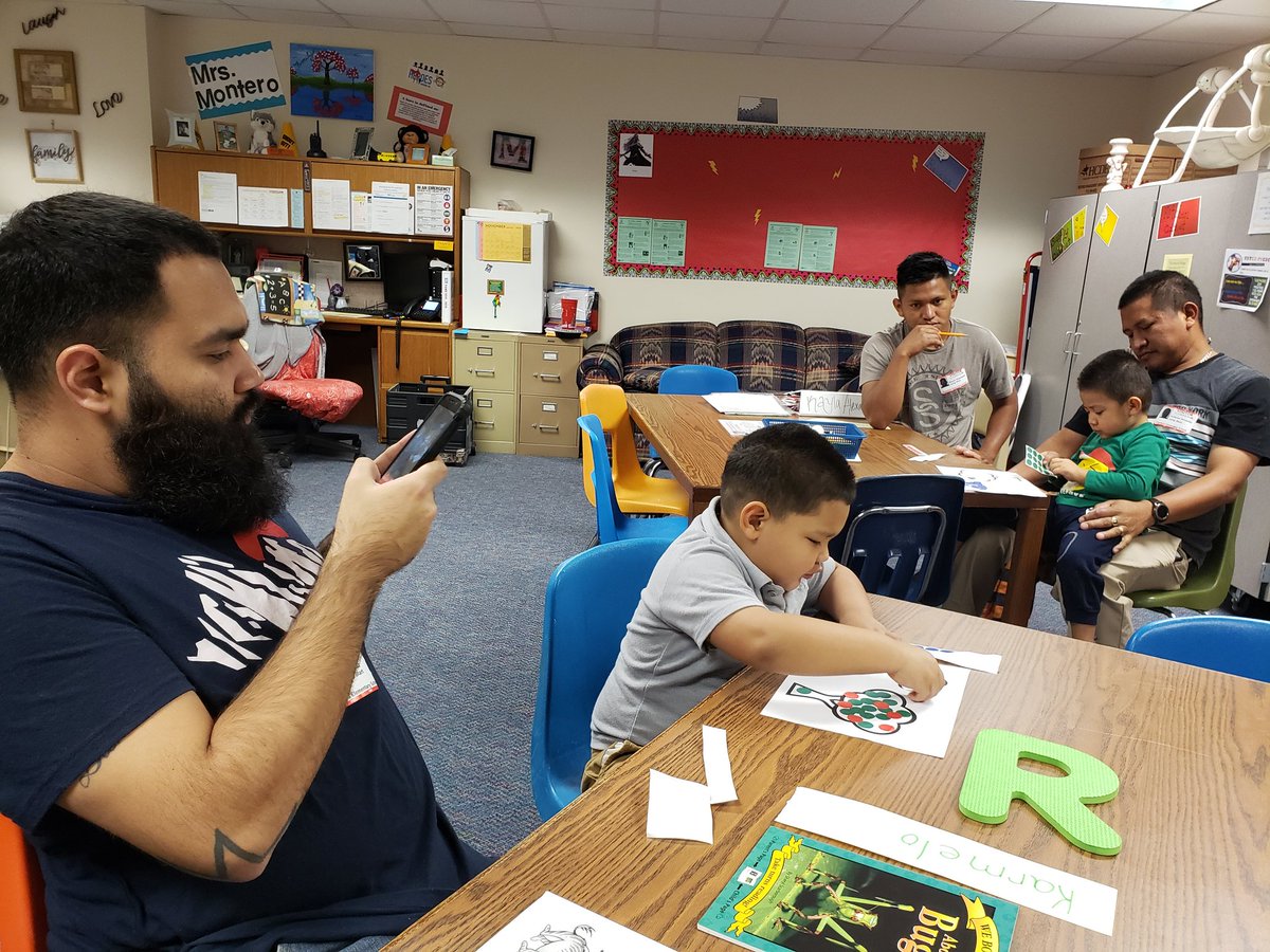 Chamber's parents watching their 3 year old child in Alief Jump Start Program doing their work in the Family Center #HeroesAmongUs