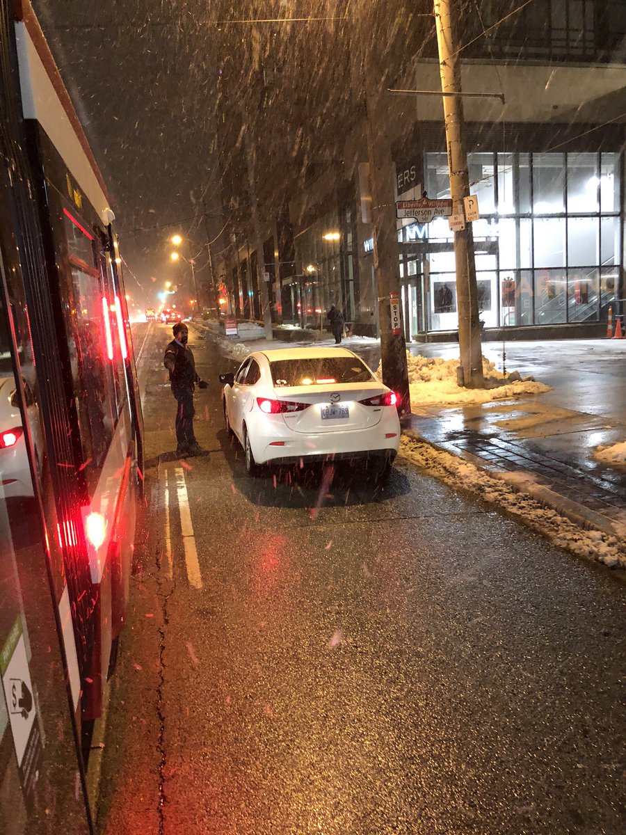 NeilsonBrad's tweet photo. Guy drives past open streetcar door, gets honked at, people exiting, keeps driving, #ttc driver gets out talks to him, keeps driving.  🤦‍♂️ smh https://t.co/4QkM8P0YAx