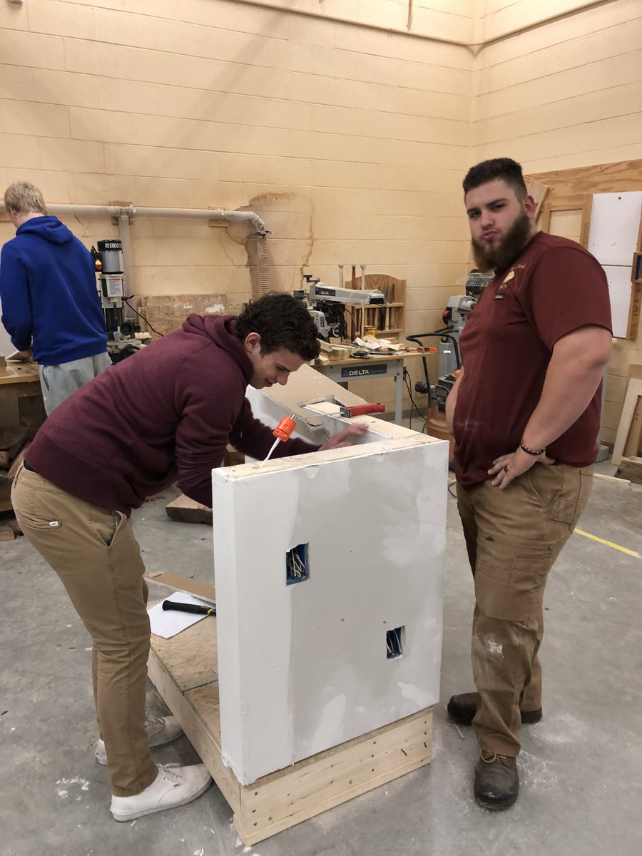 Home Maintenance students fixing holes in drywall.