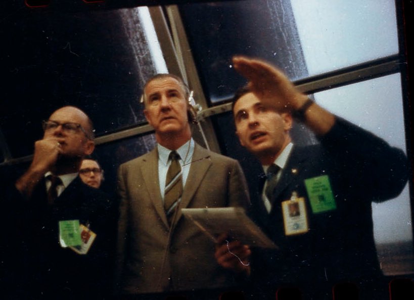 In the Launch Contol Center, KSC deputy director Albert Seipert shows concern as Bill Anders advises Vice President Spiro Agnew. Pete Conrad has just reported, "Okay, we just lost the platform, gang. I don't know what happened here; we had everything in the world drop out." 10/