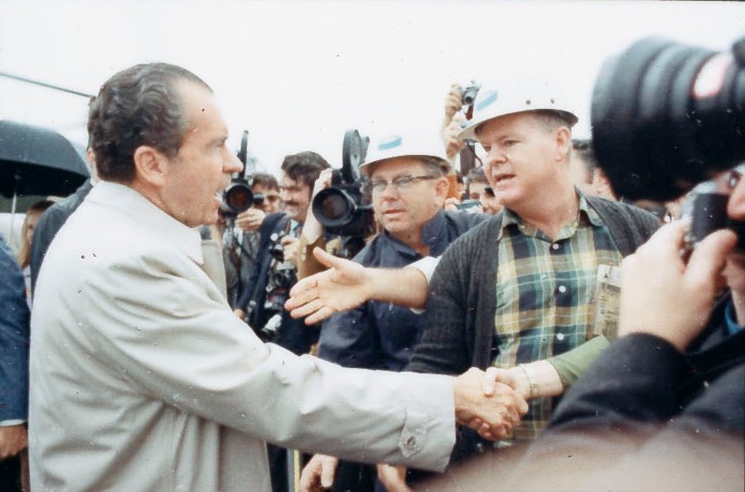 News cameras are nearly as plentiful as outstretched hands as Nixon makes his way to the VIP area. 4/