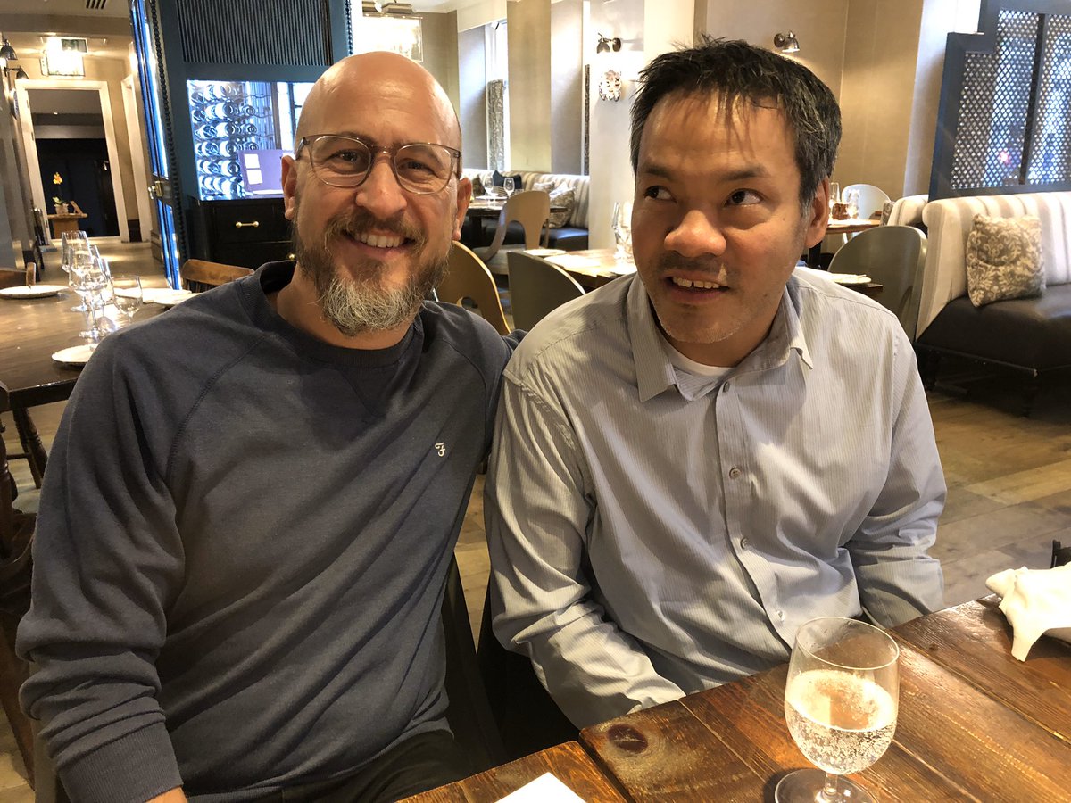 Hector and Jennison smiling at a table in swanky London hotel