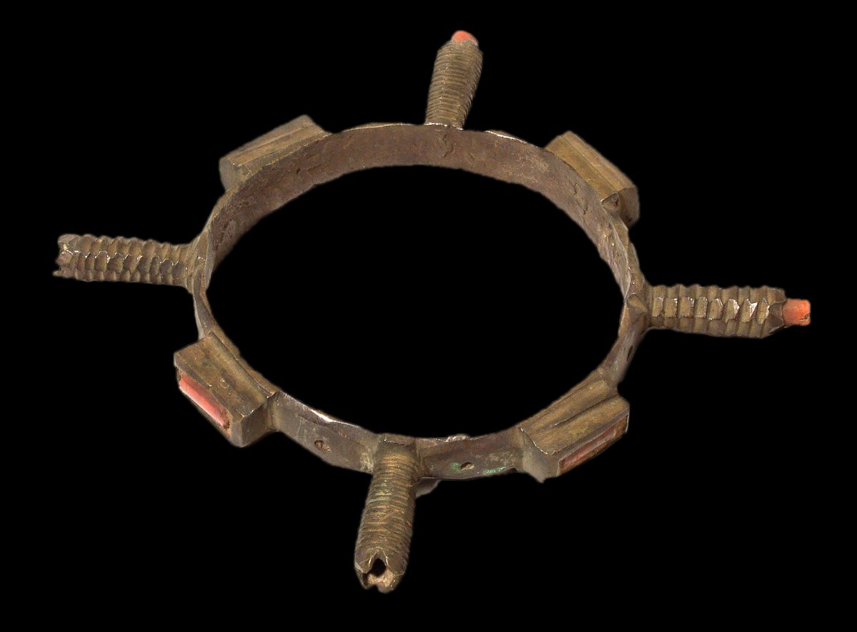 Brass armlet with four projections and insets of coral, looted in 1897 from Benin City  #BeninDisplays  @Pitt_Rivers