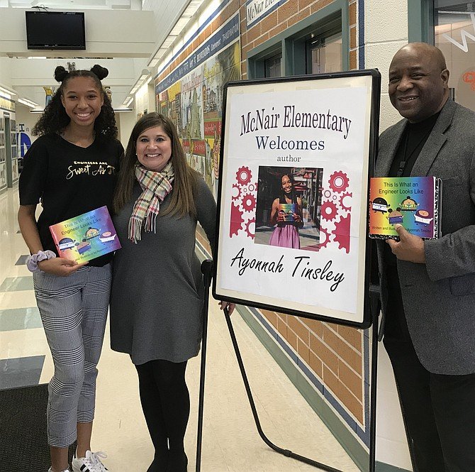 Author/illustrator and Westfield HS student Ayonnah Tinsley celebrates with FCPS principals Melissa Goddin, McNair ES and Dr. Anthony E. Copeland, Westfield, following the reading and discussion for her children's book, 'This is What an Engineer Looks Like' (2019) to students.
