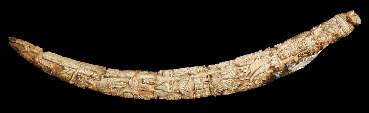Ivory tusk carved with human figures, mudfish, snakes, and crocodiles—fire damaged from the burning of Benin City in the aftermath of the British attack of 1897  #Benindisplays