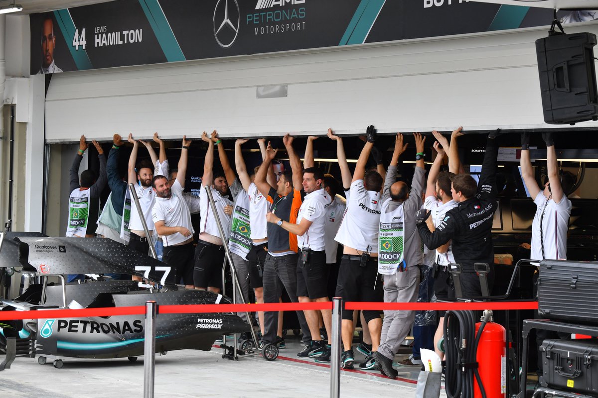 MercedesAMGF1's tweet photo. Broken garage door to start our morning? No problem! 

Teamwork makes the dream work, right guys? 😂👏

#BrazilGP https://t.co/Vu3kWzPRtn