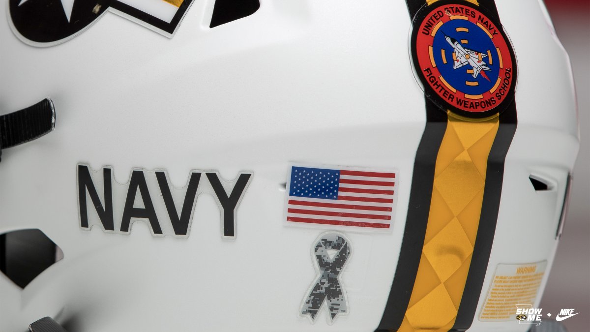 MizzouFootball's tweet photo. Saturday's helmet features:

▪️ Replica TOPGUN Patch
▪️ #Mizzou-colored national insignia found on every US military aircraft 
▪️ The numbers on each helmet represent the area code of each player. It honors the numbering system of US Navy ships

#MIZ | #TOPGUN 🐯🏈🇺🇸 https://t.co/7cfMW9kiS1