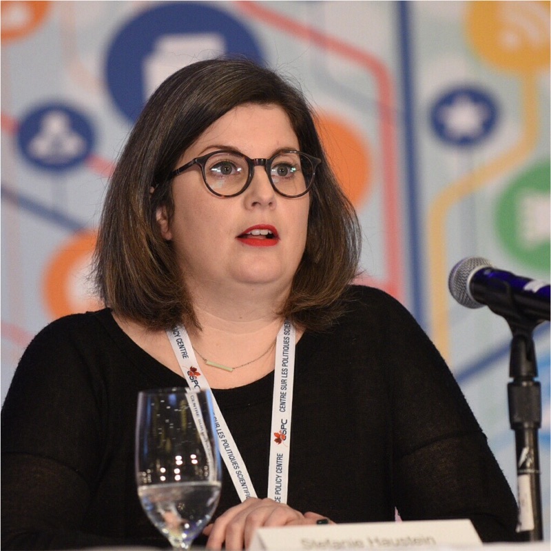 A person speaks in front of a microphone.