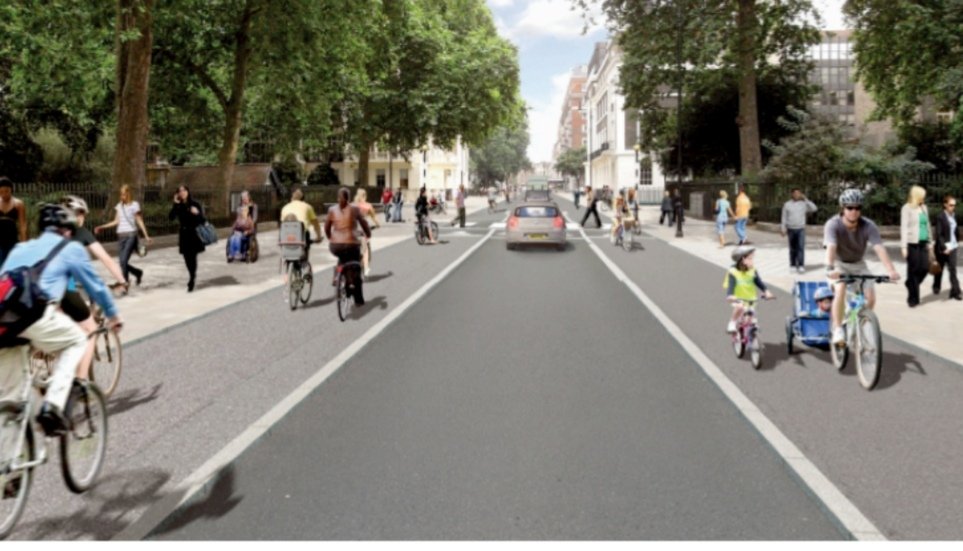 Image of Tavistock Place between Gordon Square and Woburn Square. A single lane for traffic and stepped cycle lanes either side. Trees either side.