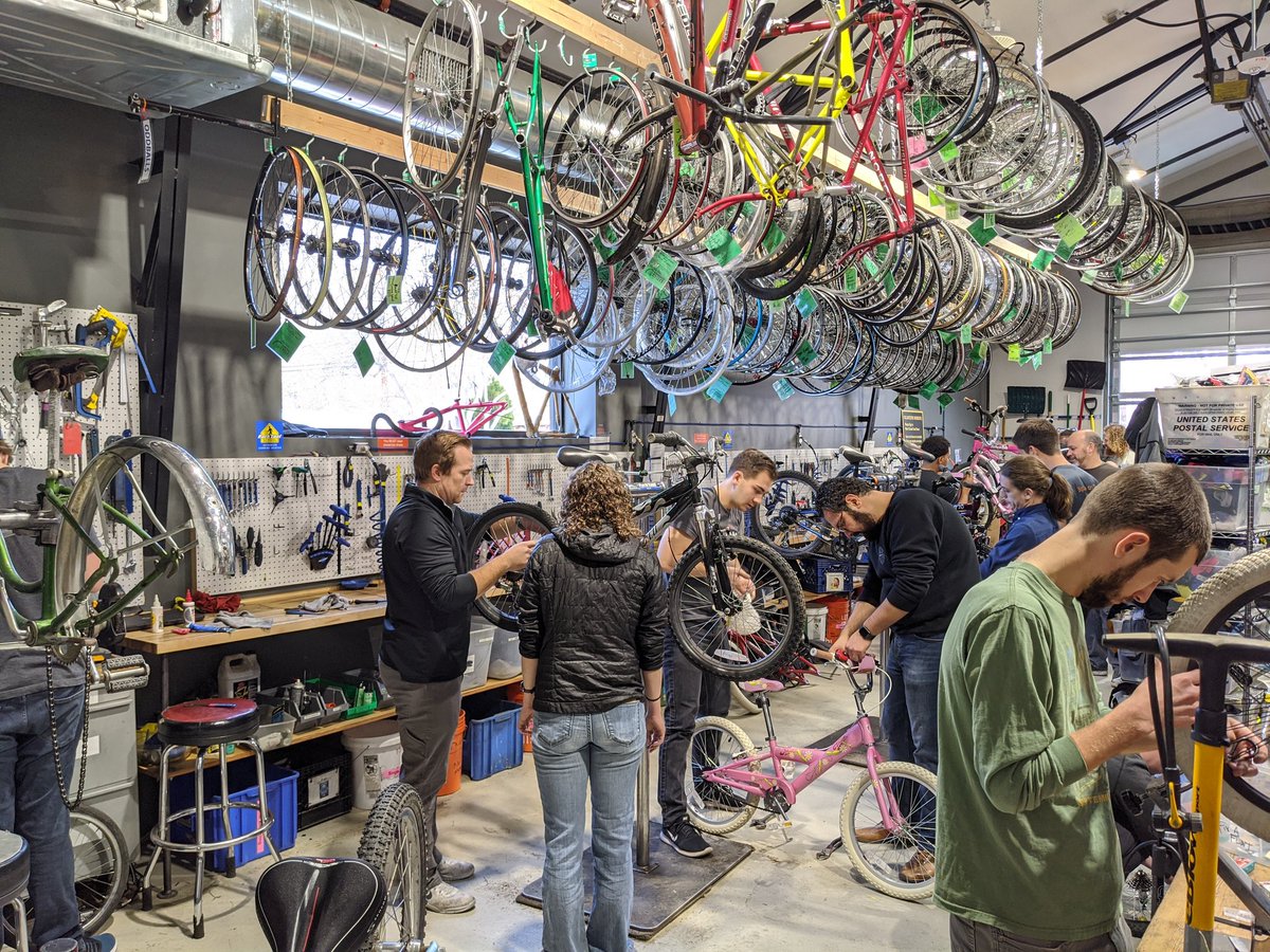 Group of volunteers repairing children's bikes.