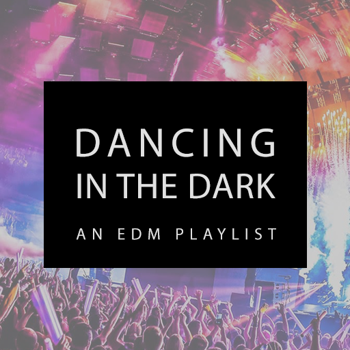 a photograph of people near a concert stage with strobe lights in mulitple colors illuminating the crowd