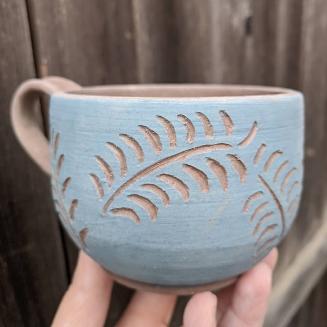 Not even a hot #kiln can keep me from #playingwithclay! I tried a little #sgraffito on this #mug while the kiln kept things 🔥 - don't worry, I wore a mask the whole time...

#safetyfirst #sgraffitopottery #bluemug #mugs #acreativedc #mydccool #madeindc #bythings #pottery #clay