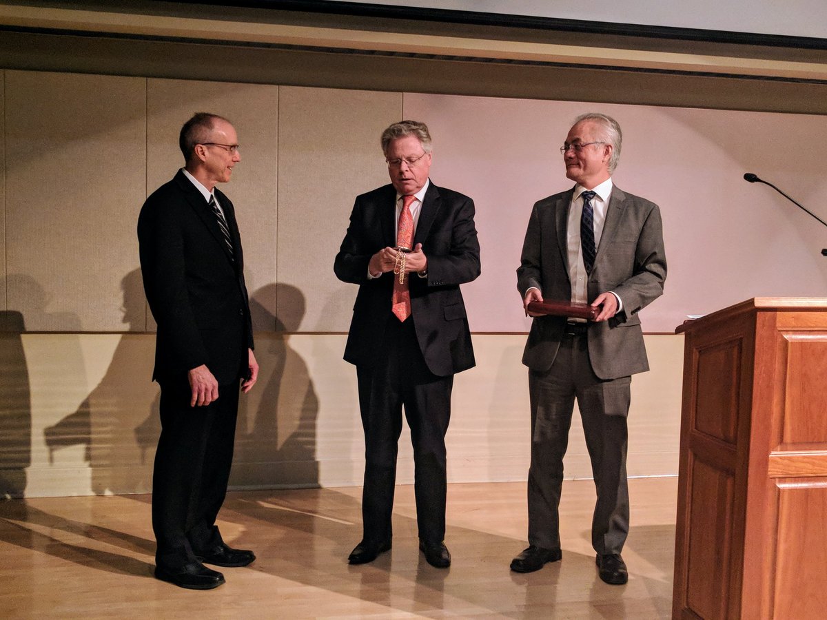 Provost Andreas Cangellaris and Dean Feng Sheng Hu present a medallion to Professor Jeff Moore.
