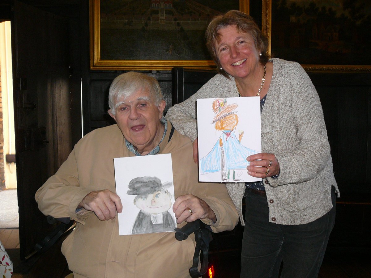 abbots400th's tweet photo. Artist Jane Allison pictured with resident Ian Henderson holding the winning portrait by Samuel Nod, aged 9 and the runners-up portraits by Anouk Nel, age 7 and Priscilla Men, age 5. They were chosen out of 16 entries from a competition held at #GuildfordHouseGallery @Gfdheritage https://t.co/2HN8FDfLrl