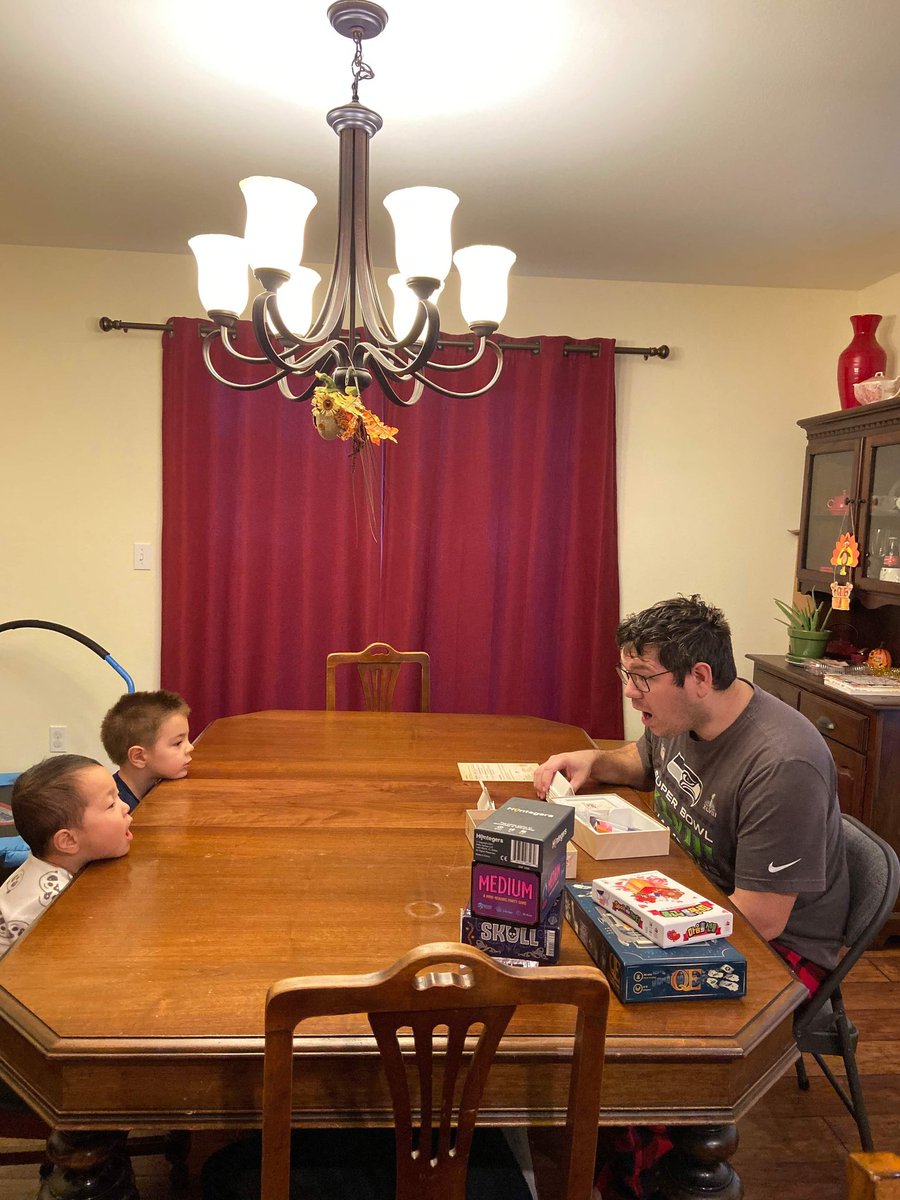 PlumpyThimble's tweet photo. My parents are visiting and my mom apparently got a picture if me trying to teach my very illiterate (very young) kids wanting to learn "Just One". https://t.co/IlAPjPq29U