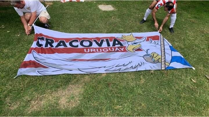 CracoviaTt's tweet photo. Cracovia w Montevideo!!!⚪️🔴⚪️🔴
Fana z flagami to prezent od naszych kibiców dla chłopaków z Urugwaju, fana z orłem pijącym Yerbę to ich prezent dla nas.
KS Cracovia de Uruguay wygrała ostatni mecz sezonu z Perła 3-2!💪👏
#WikiPasy.pl #fanatycy https://t.co/QFjhFlkjDV