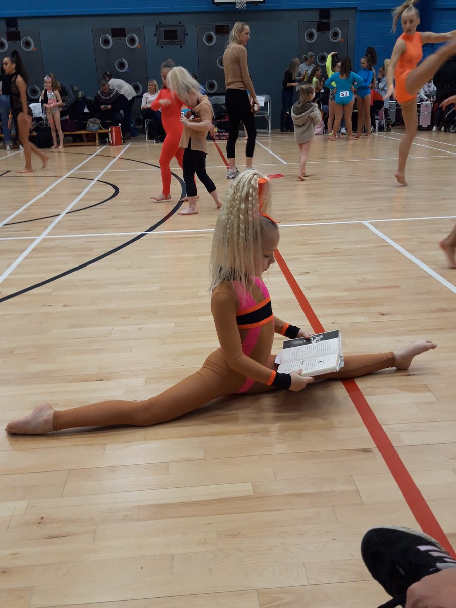Mileigh having a read while stretching for her comp this morning @BirstallAcad #bookbonanza #readingchallange