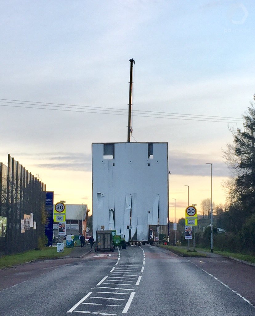 Extraordinary sight in Ballynahinch, Co Down as a petrol station forecourt roof is lifted vertically onto the road by a recovery crane. The damaged roof was knocked down early this morning by ATM raiders who hit it with a digger as they fled the scene. @PA
