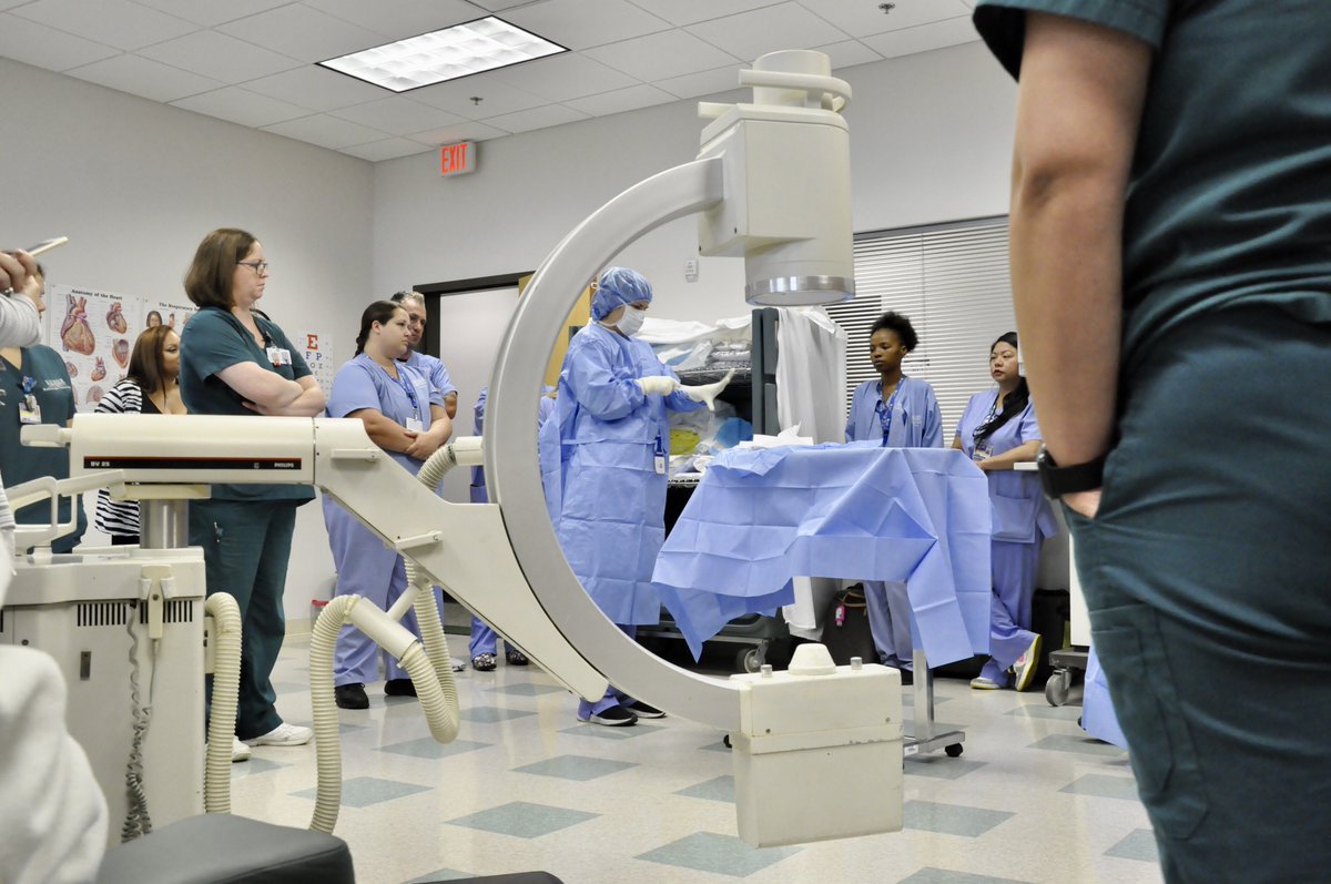 KeiserU's tweet photo. KeiserU #Tampa collaborated with #Clearwater Campus in a #workshop where the #RadiologicTech Program and #SurgicalTech Program simulated a surgical suite scenario. The students all worked together to sterile drape the c-arm in preparation for #fluoroscopic guided imaging. https://t.co/HbFLEr3meD