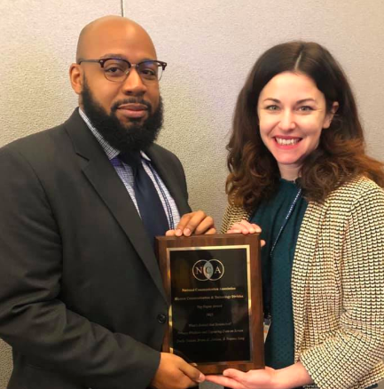 HowardUCOMM's tweet photo. This year's @NatComm Conf in Baltimore proved successful for @HowardUSLMC faculty + CCMS grad students. Pictured here: asst. prof @EmCramer and grad student Bryan Jenkins receiving a top paper award from the @HCTD_NCA Division. Award is shared with @iwbaj01 @unicanberra #nca2019 https://t.co/xPBFf0xmn3