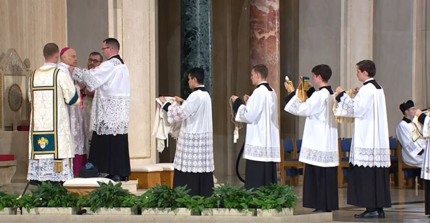 The Pontiff is vested with amice, alb, cincture, pectoral cross, stole, tunicle and dalmatical, pontifical gauntlets, chasuble, mitre, ring, maniple, and crosier.Meanwhile, bright music soars through the Basilica: "El Cantico Del Alba" meaning "Canticle to the Dawn"