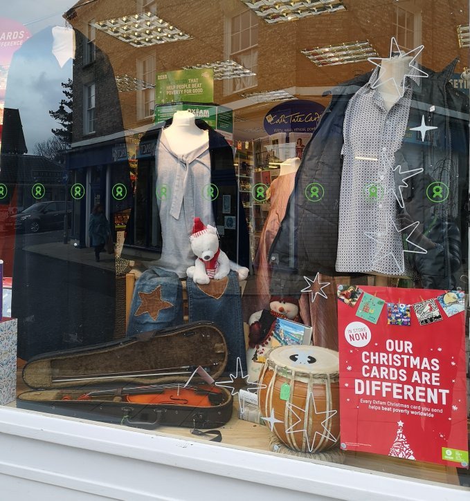 A bit of Christmas in the window, including a violin and unusual pottery drum. #FoundInOxfam #WindowDisplay