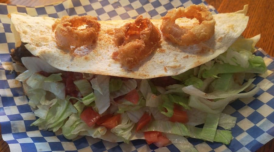 TwitCoast's tweet photo. This #HFXTacoWeek try Reilly's Lounge's Hearthstone Ultimate Taco 😋 Seasoned beef served in a 12-inch hard taco shell, wrapped in a 12-inch flour tortilla, topped with cheese, mushrooms, onion, bacon, tomato, lettuce, salsa, sour cream and three of our famous onion rings 🌮 https://t.co/gNjKaLTsBd