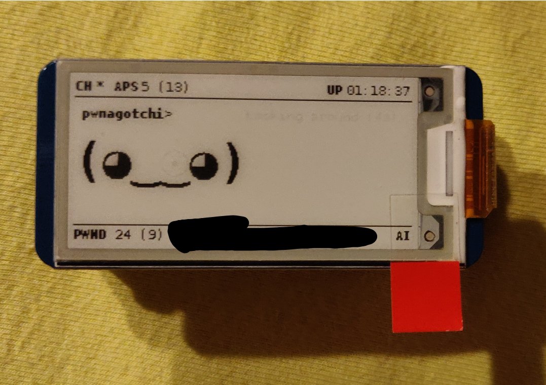 display with smiling face and pwnagotchi text