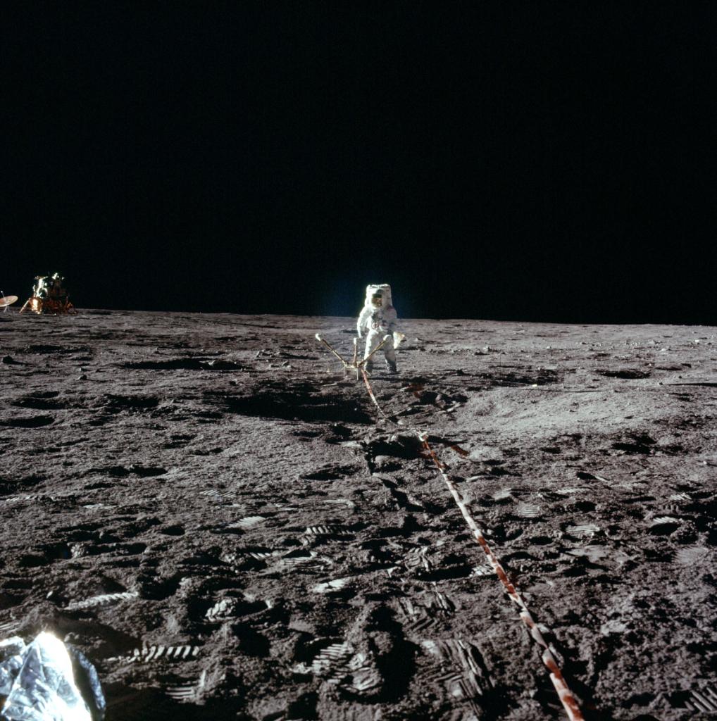 Alan Bean deploying the Lunar Surface Magnetometer with Intrepid in the background