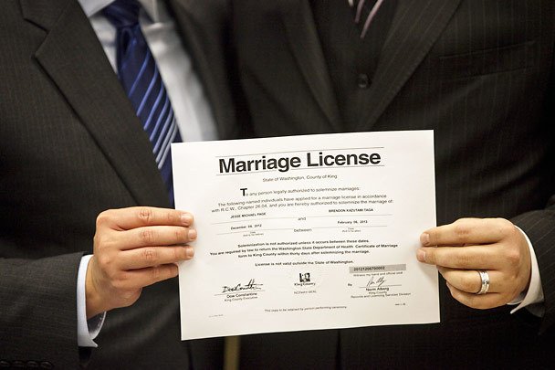 Close-up of a couple holding a marriage license on Dec. 6, 2012, as King County begins issuing the first marriage licenses to same-sex couples.