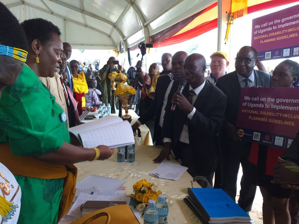 NgorokJohnson's tweet photo. Handing of a document containing signatures of Ugandans to the Minister for Gender &amp; Culture, Hon Peace Mutuzo, in support of #EqualWorld campaign and petition to implement the National Disability-Inclusive Planning Guidelines @Sightsavers Research and Policy #EqualWorld https://t.co/gwmc7EeCR3