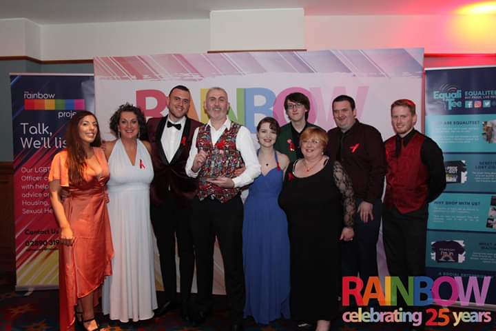 barbiecan's tweet photo. Our fantastic #Belfastpride team with our trophy at the Rainbow Ball, don't we scrub up well? Also, I'm in the other two photos, but can you find me? #whereisbarbara https://t.co/0UIssTaREQ