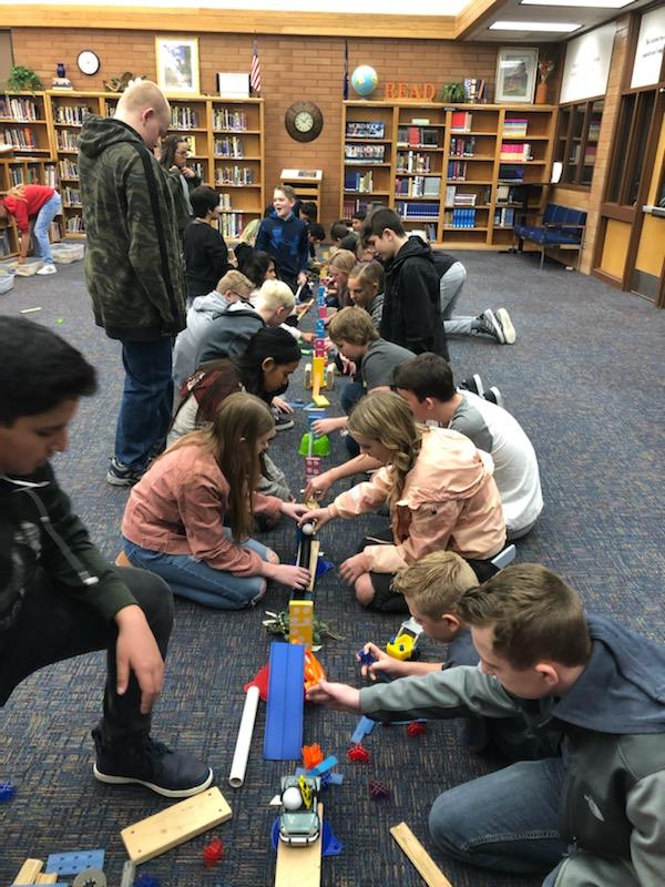 DTLALibrarians's tweet photo. At Syracuse Jr. Library this week's book feature is Star Wars!  
Lunch activities include the Cube Challenge and adult Coloring is available. Also, the Leonardo Museum On Wheels is visiting our library. This class is making a Rube Goldberg Machine. https://t.co/N8GILk7p6f