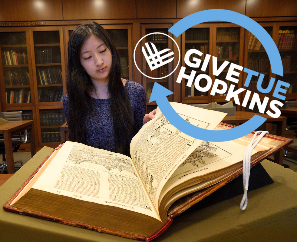 Student reading a rare book at the Milton S. Eisenhower Library