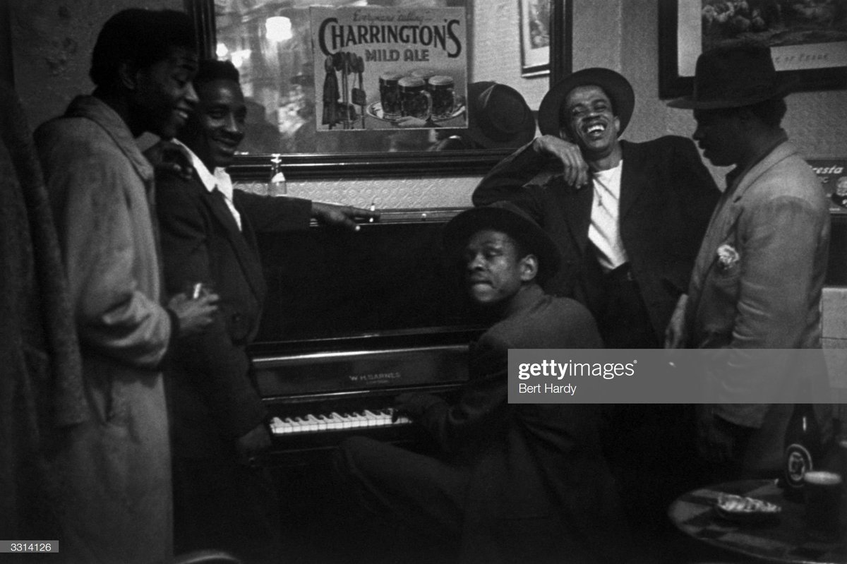 And so it began....Men relax around the piano in a pub in Stepney, London, 2nd July 1949.Photo by Bert Hardy
