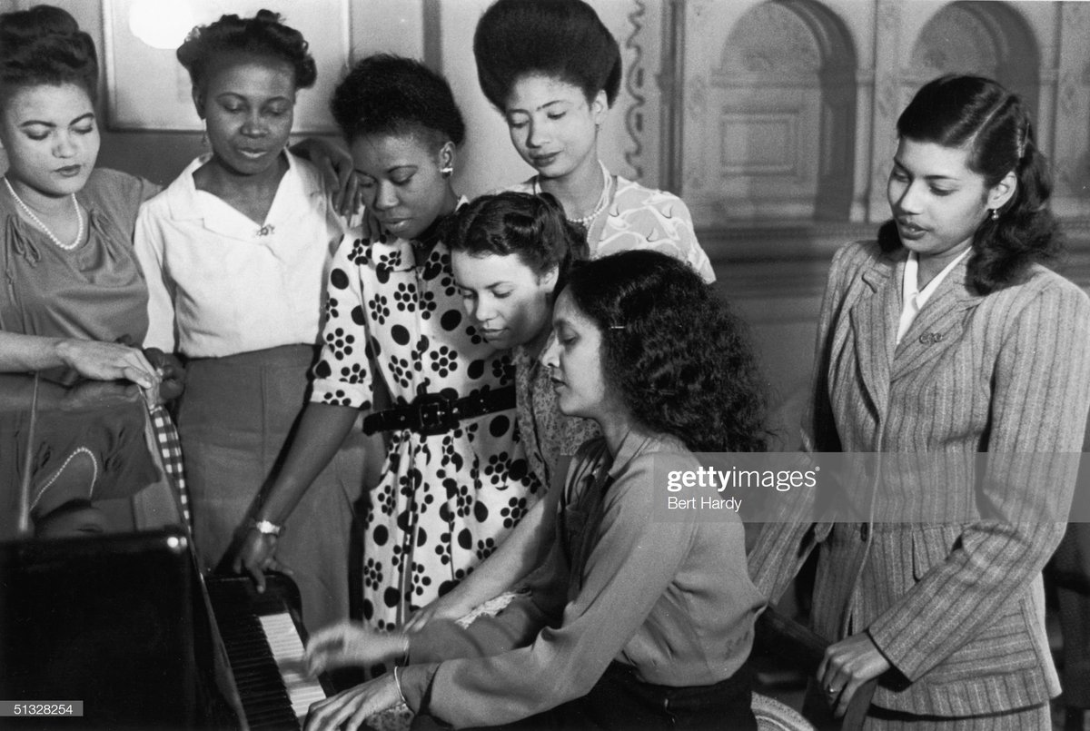 West Indian women around a piano, 2nd July 1949. Photo by Bert Hardy