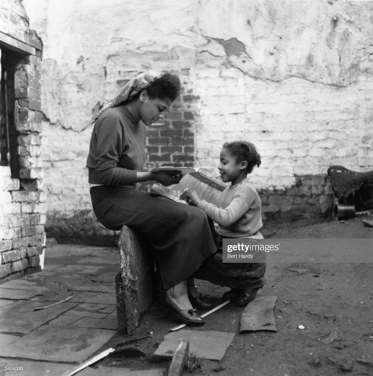 A family at home in Bute Town, one of the poorest areas of Cardiff, 1954. The area has a lively ethnic mix of families with Arab, Somali, West African, West Indian, Egyptian, Greek and many other origins. Photo by Bert Hardy