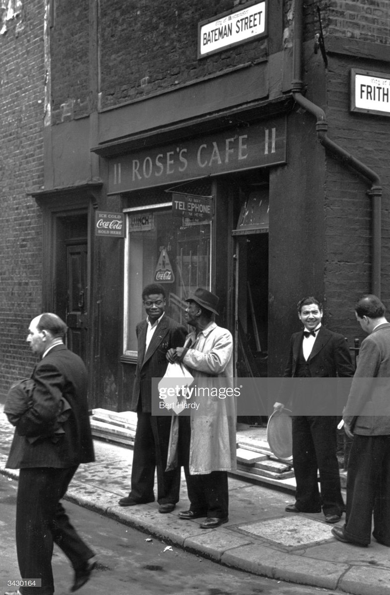 A couple of West Indian immigrants outside Roses Cafe in London's Soho area, 1949. Photo by Bert Hardy