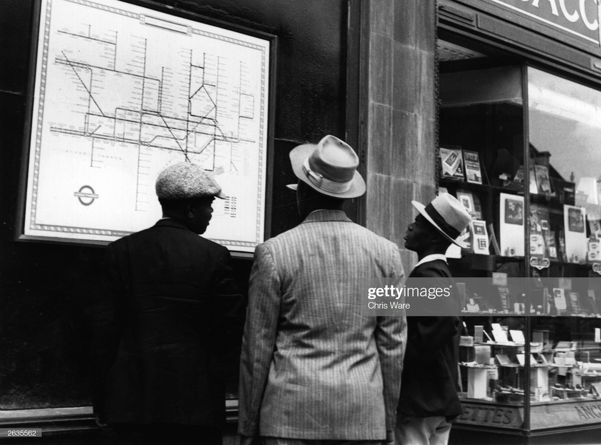 A group of Jamaican immigrants new to London scrutinise a map of the Underground, 1948. Photo by Chris Ware